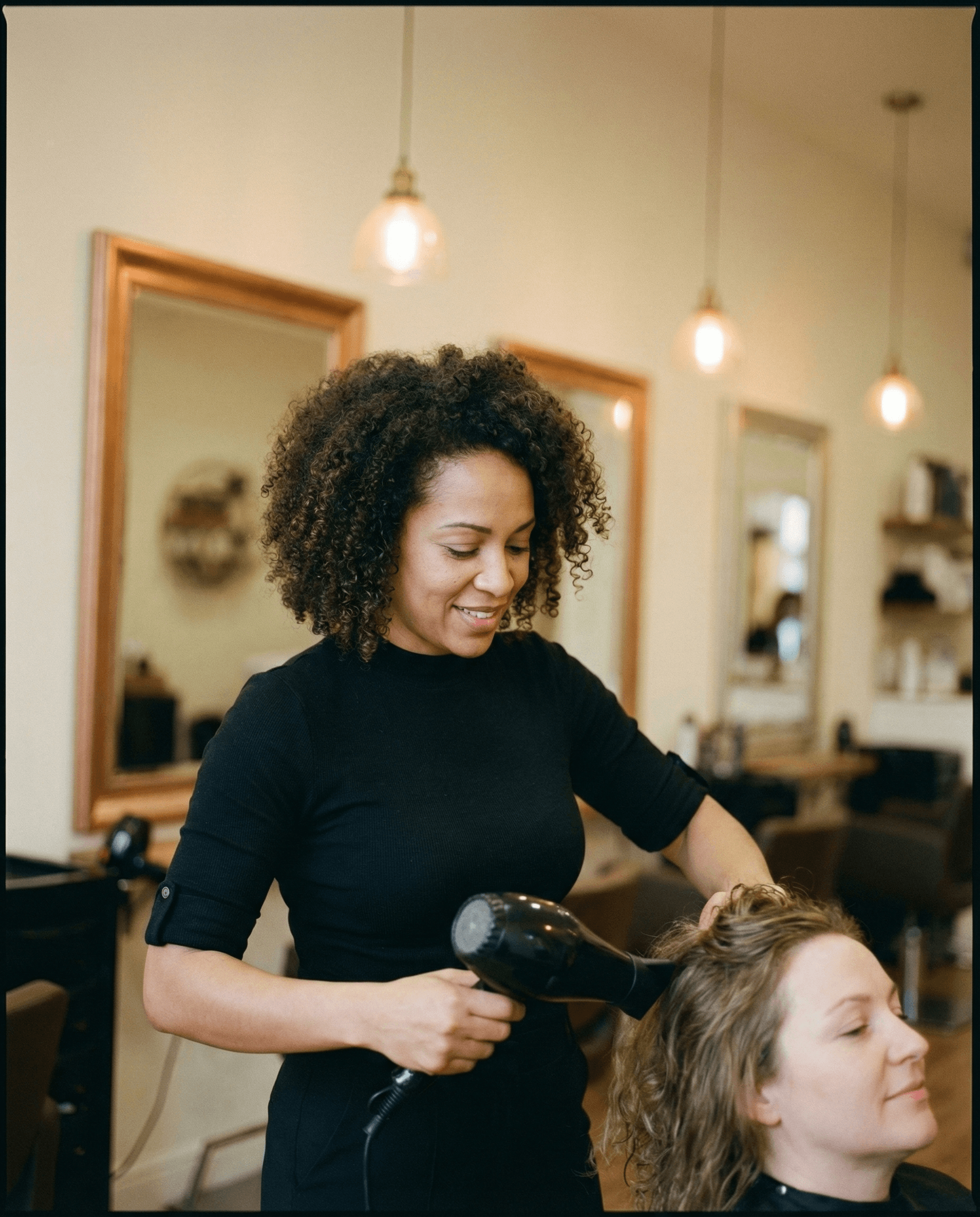 Warm minimalist hair salon interior with honey-wood floors and ambient lighting